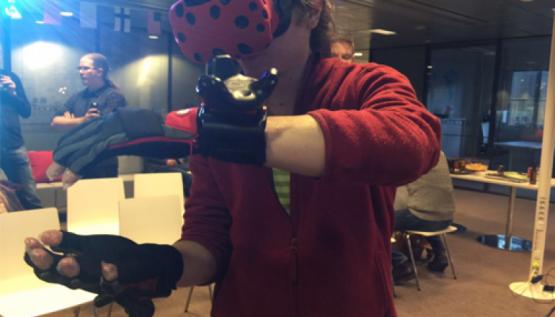 A player wears the Hi5 virtual reality glove by Noitom at TechCode in Finland..